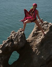 Wearing her pots fanny costume, Firebird's alluring belle stands out painless she bravely poses along the rocky cliff by the sea.
