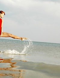 Unsophisticated redhead is acquiring naked on the beach